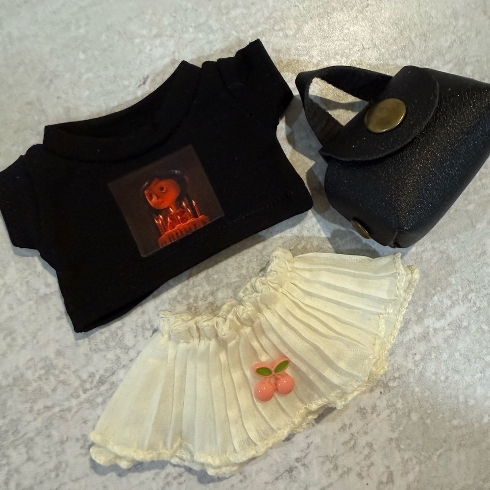 Labubu outfit Black Graphic Crop Top, Cream Pleated Mini Skirt & Black Mini Bag
